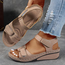 Ladies' beige wedge heel sandals with adjustable ankle straps, breathable perforated design, casual summer fashion