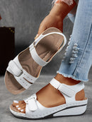 Ladies' beige wedge heel sandals with adjustable ankle straps, breathable perforated design, casual summer fashion