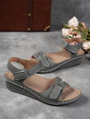 Ladies' beige wedge heel sandals with adjustable ankle straps, breathable perforated design, casual summer fashion