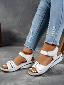 Ladies' beige wedge heel sandals with adjustable ankle straps, breathable perforated design, casual summer fashion