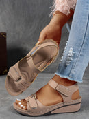 Ladies' beige wedge heel sandals with adjustable ankle straps, breathable perforated design, casual summer fashion